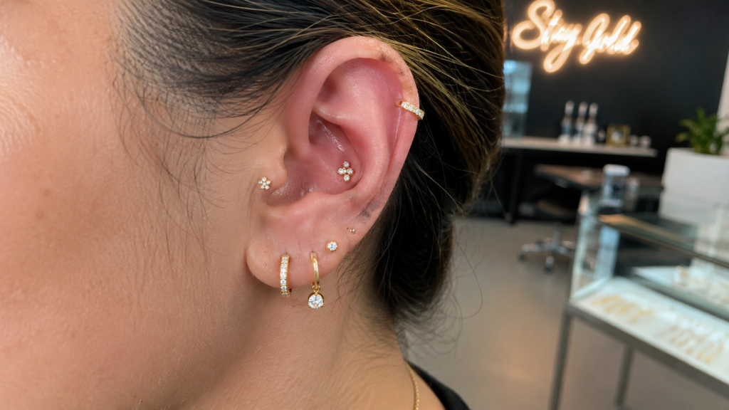Detailed curated ear piercings with helix, conch, tragus, and stacked lobe jewelry